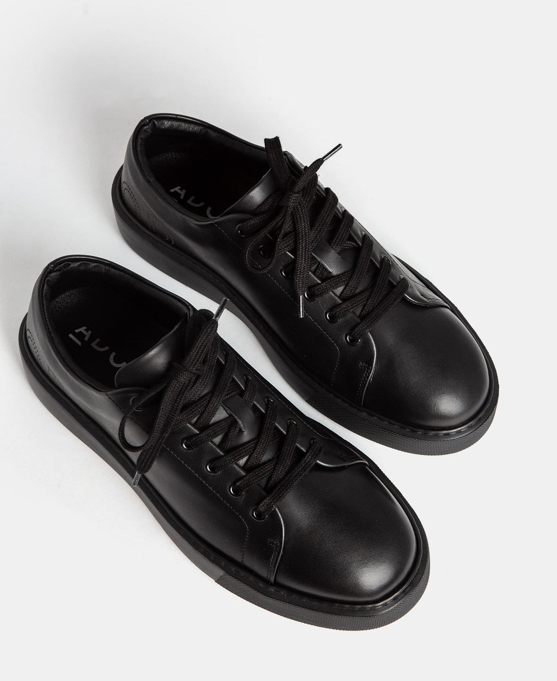 Men Shoes | Black Die-Cut Logo Sneaker by Spanish designer Adolfo Dominguez
